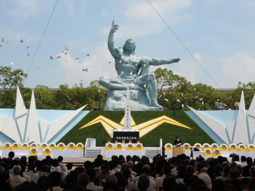 Doves fly over the Peace Statue during a memorial ceremony to mark the 70th anniversary of the atomic bombing of Nagasaki on Sunday.