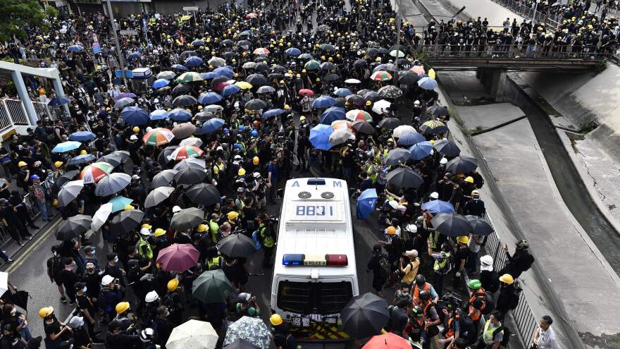 A crowd of protesters blocks a police van during a demonstration on Saturday.