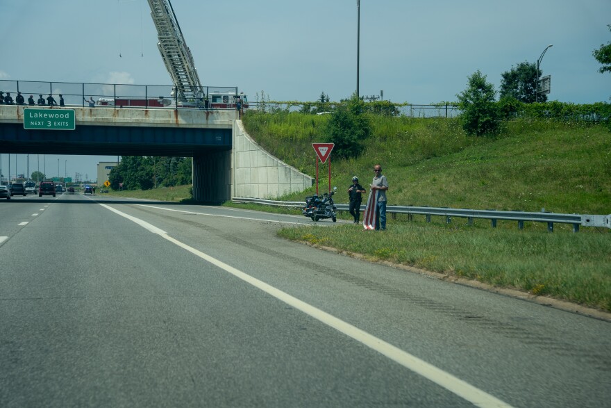 Bystanders watch the procession for fallen Lorain police Officer Phillip Wagner on I-90 East.