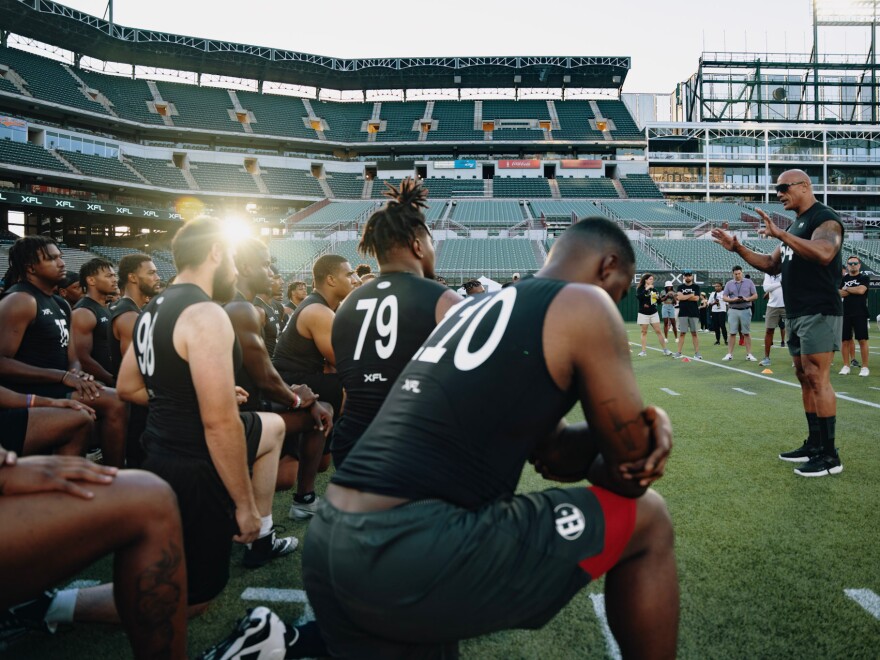 Dwanye "The Rock" Johnson speaks to those participating in the XFL Showcase at Choctaw Stadium in Arlington, Texas, on Sunday.