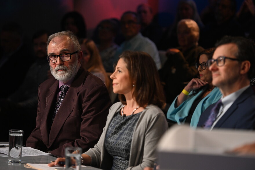 WVIA News politics reporter Borys Krawczeniuk, left, asks a question during the debate.