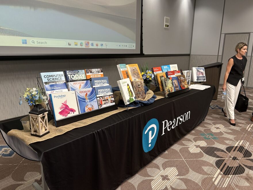 A presenter walks past a textbook display at an Oklahoma State Textbook Committee meeting July 16. The focus this year is social studies, and new controversial standards are being used to evaluate the materials.