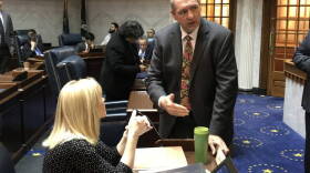 Elections Committee Chair Sen. Greg Walker (R-Columbus) talks with fellow lawmakers ahead of a committee meeting.