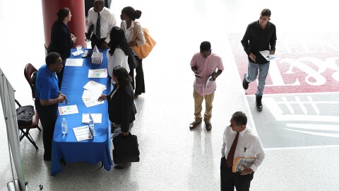 People attend the JobNewsUSA job fair at the BB&T Center on Nov. 15 in Sunrise, Fla.