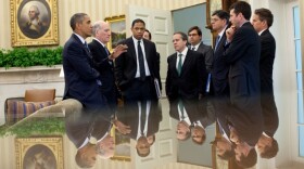 President Barack Obama talks with members of his staff in the Oval Office following a meeting with the Congressional Leadership, July 7, 2011.