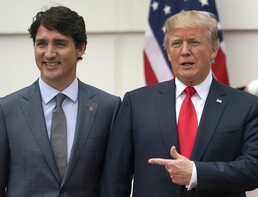 FILE - President Donald Trump and Canadian Prime Minister Justin Trudeau pose for a photo as Trudeau arrives at the White House in Washington, on Oct. 11, 2017.