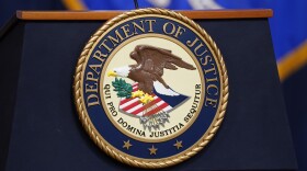 FILE - The seal for the U.S. Department of Justice is displayed on a podium in Washington, April 13, 2023. The DOJ on Thursday, May 4, said an environmental justice probe found Alabama engaged in a pattern of inaction and neglect regarding the risks of raw sewage for residents in an impoverished Alabama county and announced a settlement agreement with the state. (AP Photo/Evan Vucci, File)