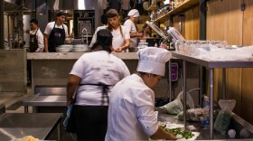Cooks prepare dinner for a gourmet soup kitchen that feeds people with what society has thrown away as leftovers. This concept was created by chef Massimo Bottura at his restaurant RefettoRio Gastromotiva in Rio de Janeiro.