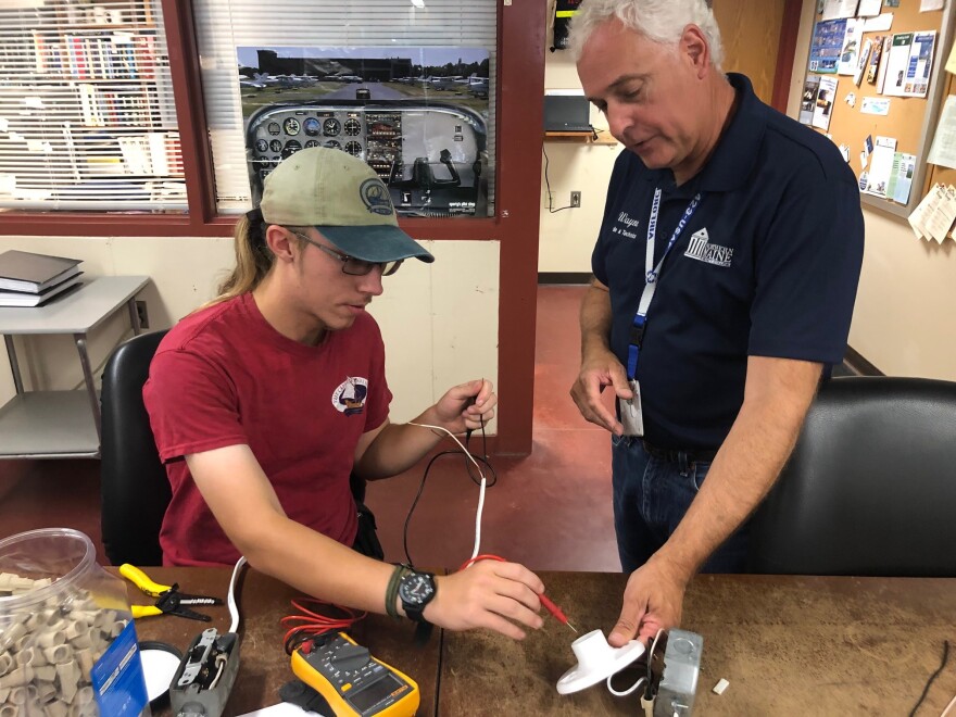 Wayne Kilcollins, an instructor in the wind energy program, and student Maxwell Osborne doing a lab assignment at Northern Maine Community College.