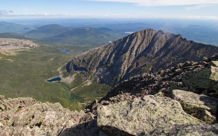 Panoramic view from above of Katahdin and land surrounding the mountain