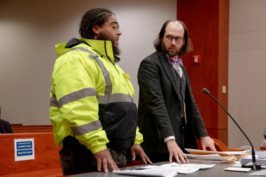 Jean Conquistador, left, speaks at a trial at the New Britain courthouse, next to his deputy assistant public defender, Joshua Perldeiner. Conquistador was incarcerated for about two months earlier this year because he couldn't afford to pay the bond set at $45,000. YEHYUN KIM / CTMIRROR.ORG