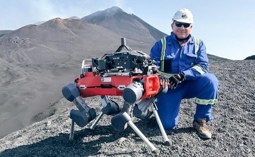 Dr. Andres Diaz on Mount Etna with the ARAMMIS legged robot that is carrying the INFICON Transpector® MPH (quadrupole mass spectrometer)