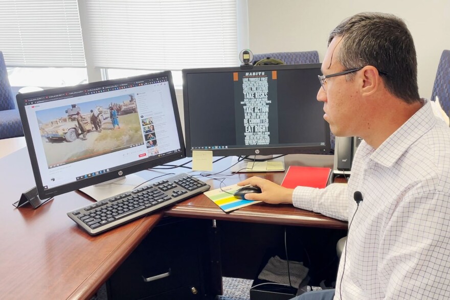  Ali Rasouly, a former translator for U.S. Marines in Afghanistan, watches news from his homeland. He now lives in San Diego.