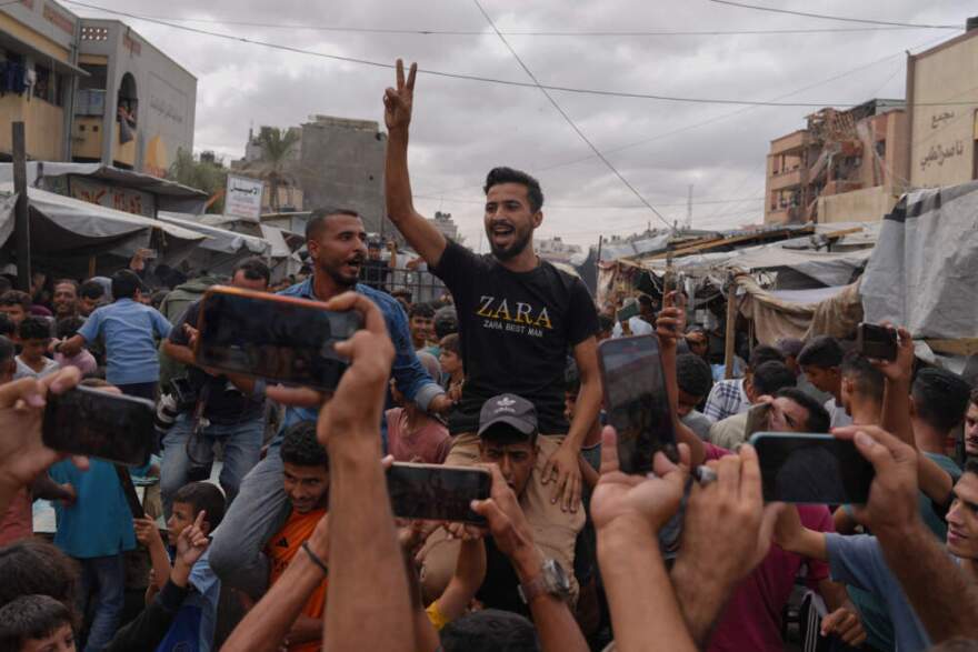 Palestinians celebrate following the announcement that Israel and Hamas have agreed to the first phase of a peace plan to pause the fighting, in Khan Younis, southern Gaza Strip, Thursday, Oct. 9, 2025. Celebrations remain limited, as relief is mixed with mourning and concern for what comes next. (Jehad Alshrafi/AP)