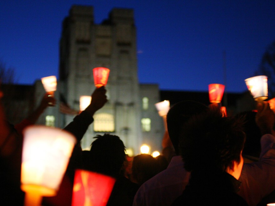 Mourners hold candles at a vigil at Virginia Tech to honor victims in a campus shooting in 2007. The shooter's name should have been in a national database, preventing him from legally buying guns, but it wasn't.
