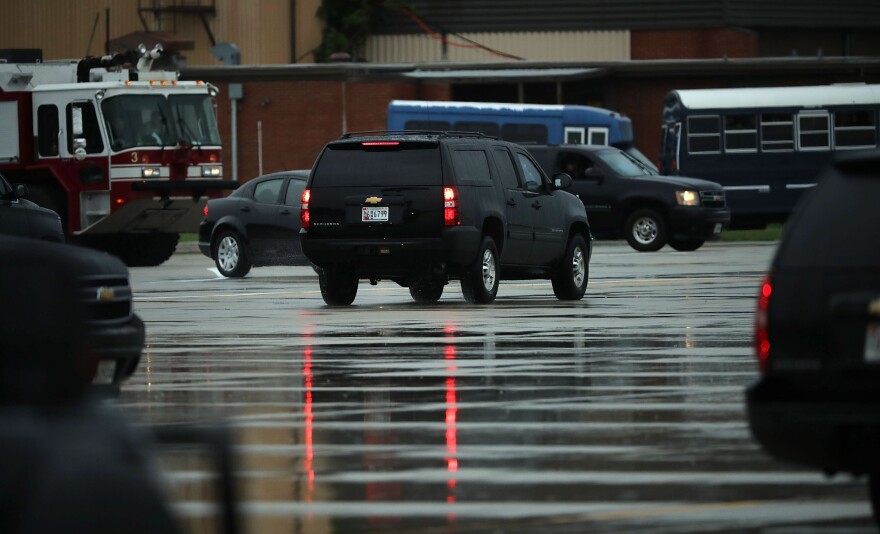 The vehicle carrying outgoing White House chief of staff Reince Priebus leaves ahead of the presidential motorcade on Friday in Joint Base Andrews, Md.