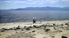 A man fishes for tilapia along the receding banks of the Salton Sea near Bombay Beach, Calif., April 30, 2015. (Gregory Bull, File/AP)
