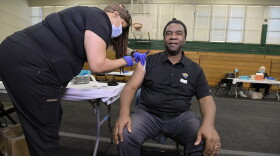 Former Jacksonville Mayor Alvin Brown gets his second dose of the Moderna vaccine from medical assistant Andressa Randolph in April.