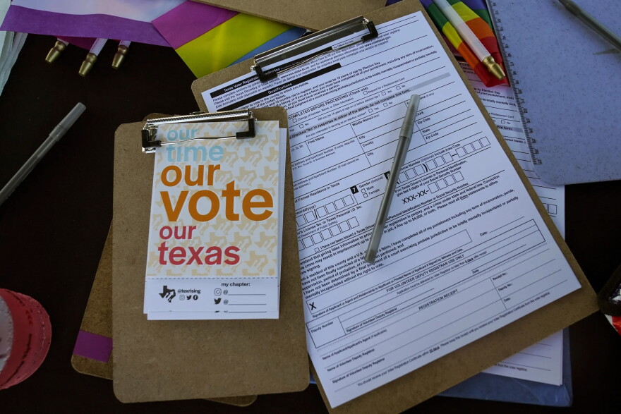 Voter registration applications are seen at the Texas Rising tent during a Pride celebration in Corpus Christi, Texas, on Oct. 5, 2024.