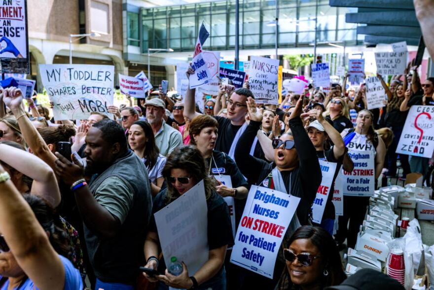Nurses hold signs outside of Brigham and Women's Hospital in Boston during a one-day strike for better wages. (Jesse Costa/WBUR)