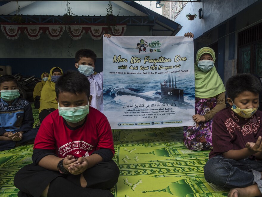 Students and teachers at an Islamic school in Surabaya pray for the 53 crew members aboard an Indonesian navy submarine that went missing off the coast of Bali during training exercises this week.