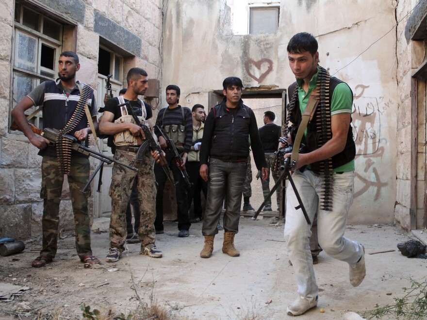 Free Syrian Army fighters prepare to raid a house in Dara'a on May 16.