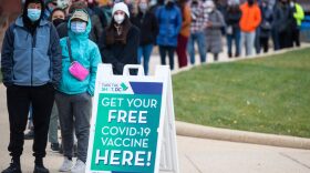 People wait in line at a walk-up vaccination site in Washington, DC.