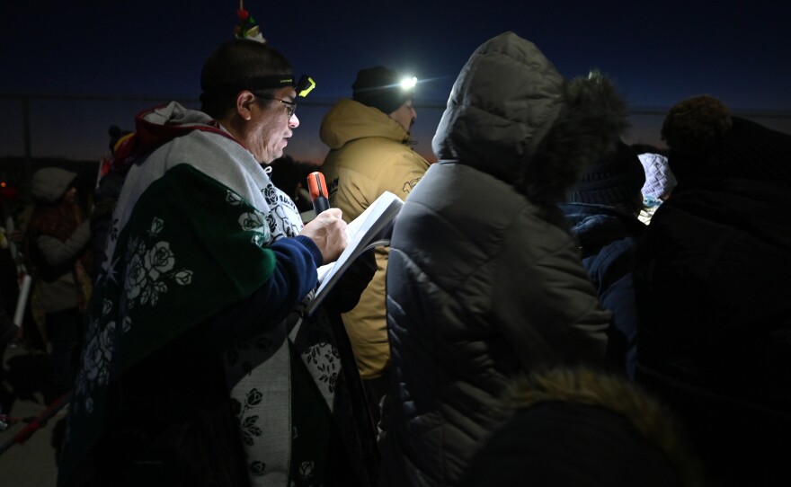 Claus Casales leads the procession in prayer during Friday's Our Lady of Guadalupe procession in Wilkes-Barre. The procession, which began at 4 p.m. on North Sherman Street, took about two hours in 20-degree temperatures.