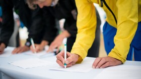 people appear to be filling out a ballot