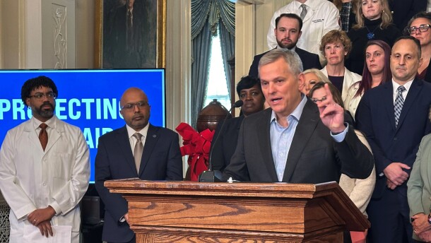 North Carolina Gov. Josh Stein, right, speaks while Dr. Benjamin Simmons with the North Carolina Academy of Family Physicians, far left, and state Health and Human Services Secretary Dr. Dev Sangvai listen to Stein discussing the restoration of Medicaid reimbursement rates to pre-October levels at an Executive Mansion news conference on Wednesday, Dec. 10, 2025 in Raleigh, N.C.
