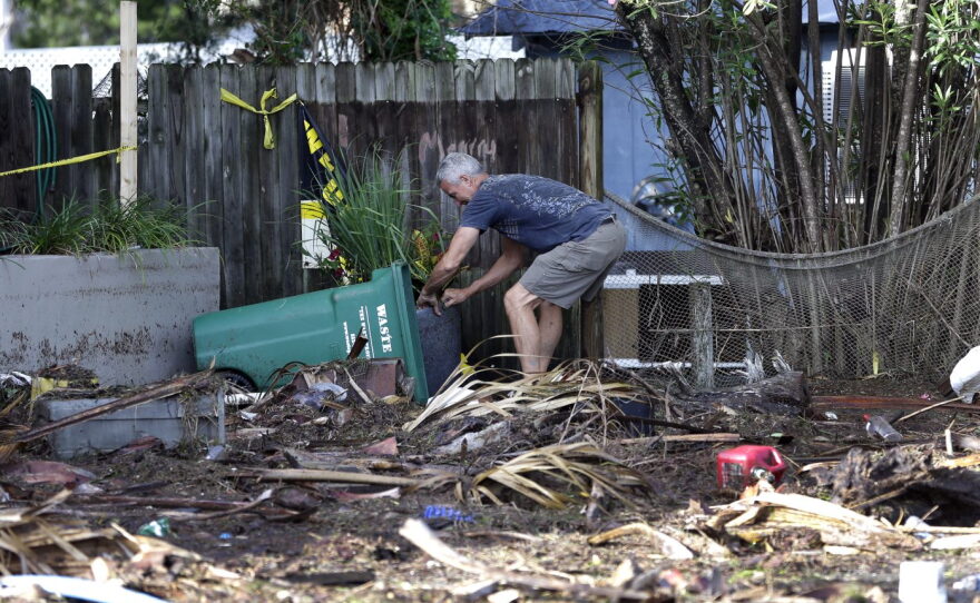 A Cedar Key, Florida, business owner clears debris outside his office after Hurricane Hermine. The hurricane was downgraded to a tropical storm after it made landfall in Florida and, now off the Northeast coast, is expected to weaken. (AP Photo/John Raoux)