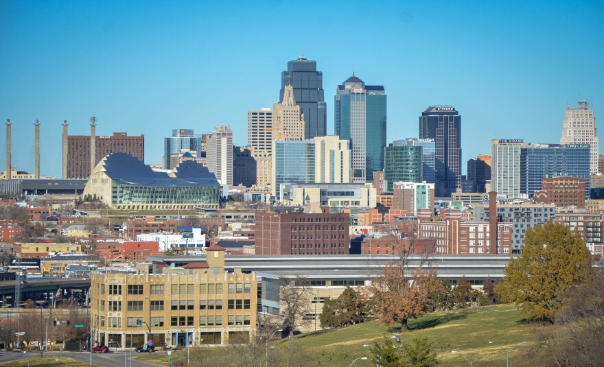 Many buildings are shown against a clear blue sky. The view is Kansas City's skyline.