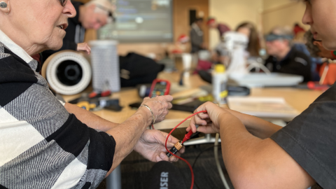 a woman and boy work on a repair project at a Fixit Clinic