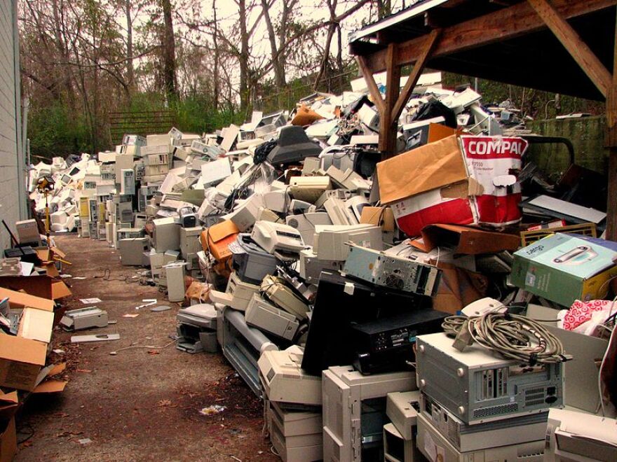 A pile of discarded computers and other electronics.