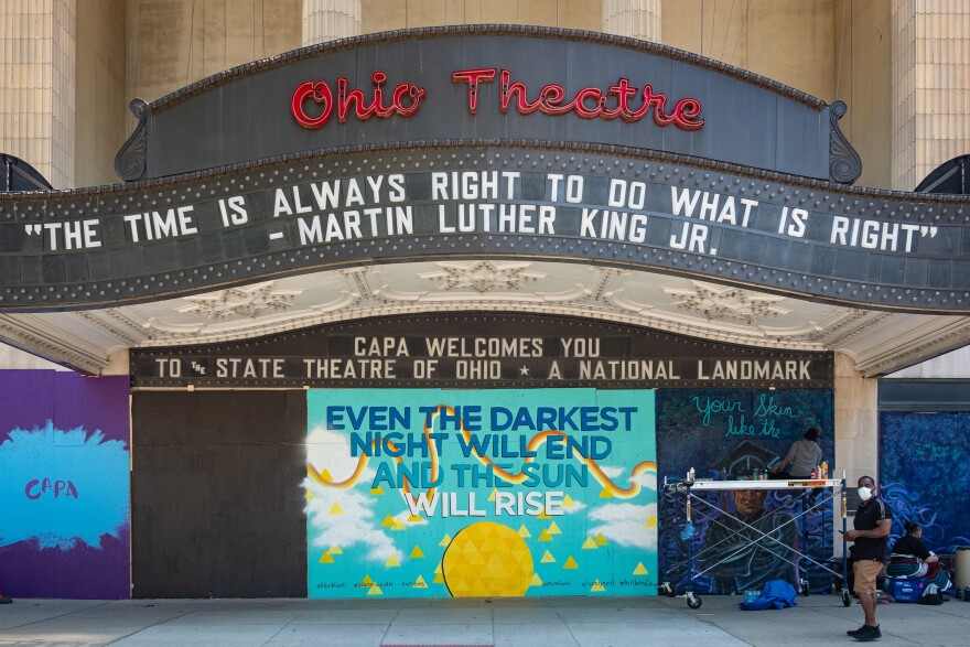 The glass doors of the Ohio Theatre were damaged during protests on May 28. They've been covered up by a quote from Les Miserables.