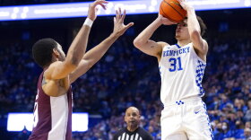 Kentucky guard Kellan Grady (31) shoots the ball over Mississippi State forward Garrison Brooks (10) during the first half of an NCAA college basketball game in Lexington, Ky., Tuesday, Jan. 25, 2022. (AP Photo/Michael Clubb)
