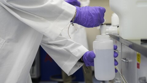 FILE - Logan Feeney pours a water sample with forever chemicals, known as PFAS, into a container for research, April 10, 2024, at a U.S. Environmental Protection Agency lab in Cincinnati.