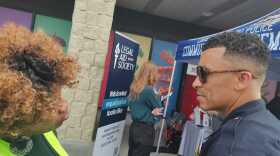 The LMPD police chief talks with a woman outside a grocery store.