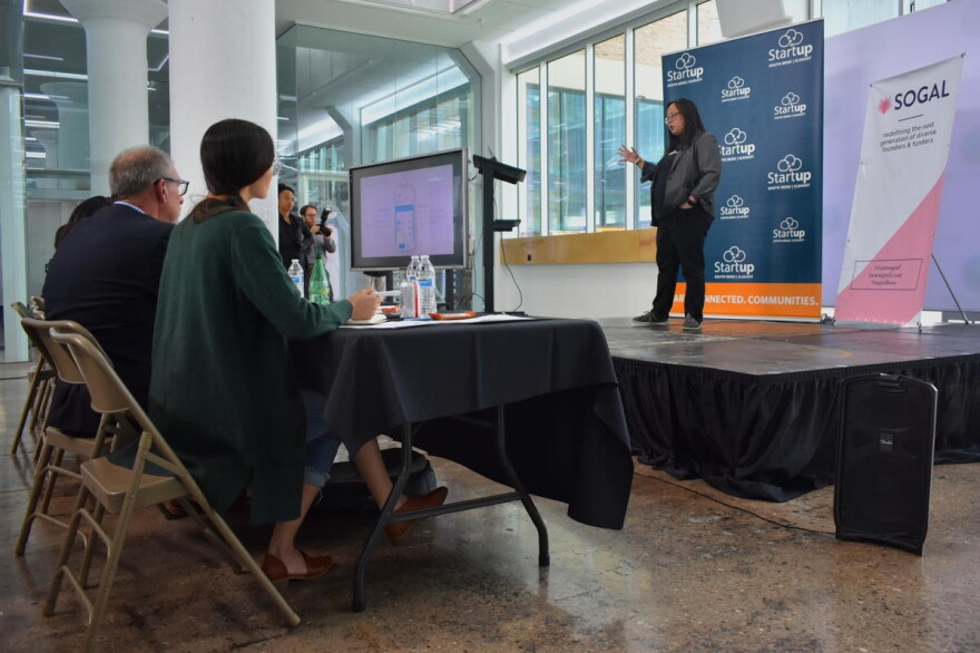 Daisy Pham of Halo App pitches her business concept of a phone application for small-dollar loans to a panel of venture capitalists.