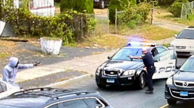 Traffic camera screen grab of Hartford officer confrontation with armed man.