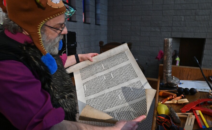 Rabbi Daniel Swartz shows the Megillah, which contains the stories told during Purim.