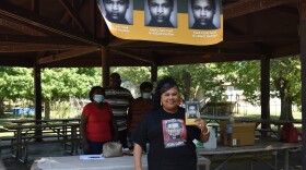 Gloria Clark-Jackson holds up a copy of her book during a signing event on Sept. 5, 2020 at Martin Luther King Jr. Park in Peoria.