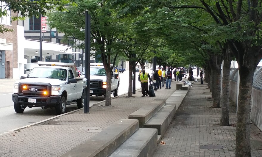 Police and city workers moved in to one of the camps along Third Street, Tuesday morning.