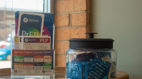 A jar of condoms and pamphlets for HIV prevention medication sits inside the waiting room of the New Hope Wellness Center, the clinical arm of Guiding Right. The public health nonprofit has received direct federal funding for decades, but now those dollars are being redirected to state health departments.