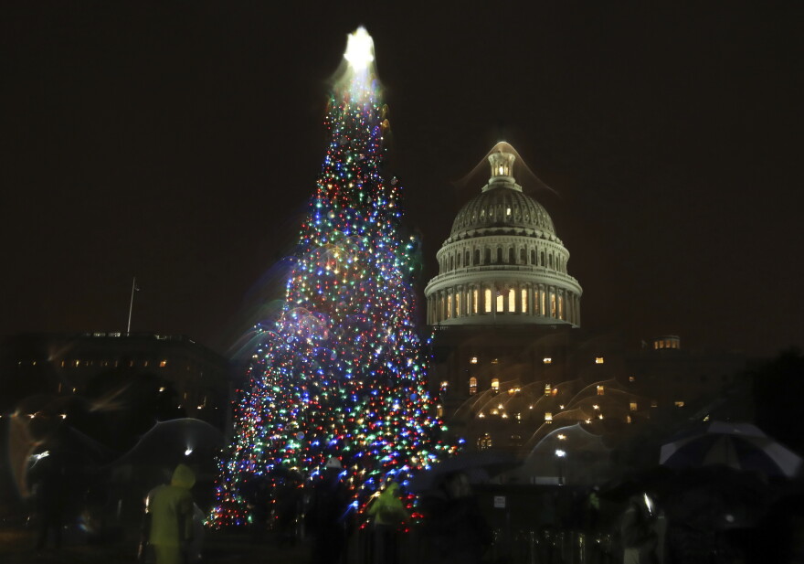 The U.S. Capitol Christmas Tree is lit up during a ceremony on the West Front of the Capitol in Washington, Tuesday, Dec. 6, 2016. The Capitol Christmas Tree is an 80-foot Engelmann Spruce from the Payette National Forest in Idaho.