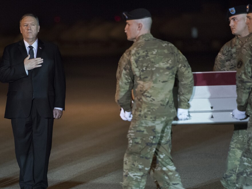 An Army carry team moves a transfer case containing the remains of Sgt. 1st Class Elis Barreto Ortiz, 34, past Secretary of State Mike Pompeo. Ortiz was killed in action last week when an improvised explosive device detonated near his vehicle in Kabul, Afghanistan.