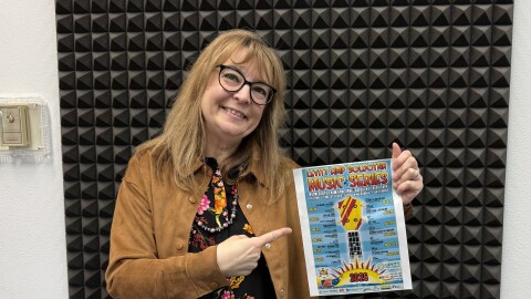 Sara Hondel holds the 2026 Levitt Amp Soldotna Music Series flyer in the KDLL studio on Friday, May 8, 2026 in Kenai, Alaska.
