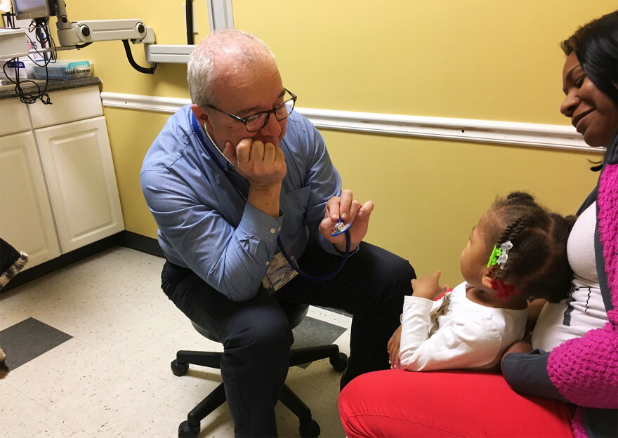 Pediatrician Ken Haller tries to get 3-year-old Azaya Clemons to laugh during a 2018 checkup at Danis Pediatrics in Midtown.