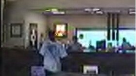 A hidden camera snaps a picture of the bank robber.