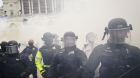 Supporters loyal to President Donald Trump clash with authorities before successfully breaching the Capitol building during a riot on the grounds, Wednesday, Jan. 6, 2021. (John Minchillo/AP)